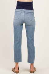 woman wearing light blue maternity jeans with a frayed hem, showing a fitted waistband and back view