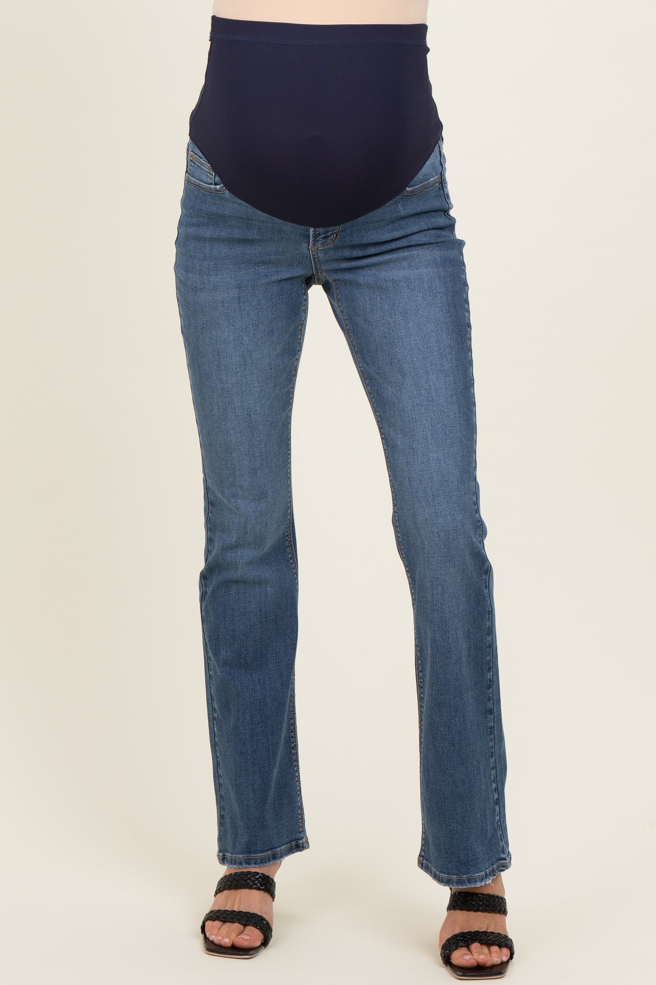 woman wearing dark blue maternity jeans with a supportive belly panel