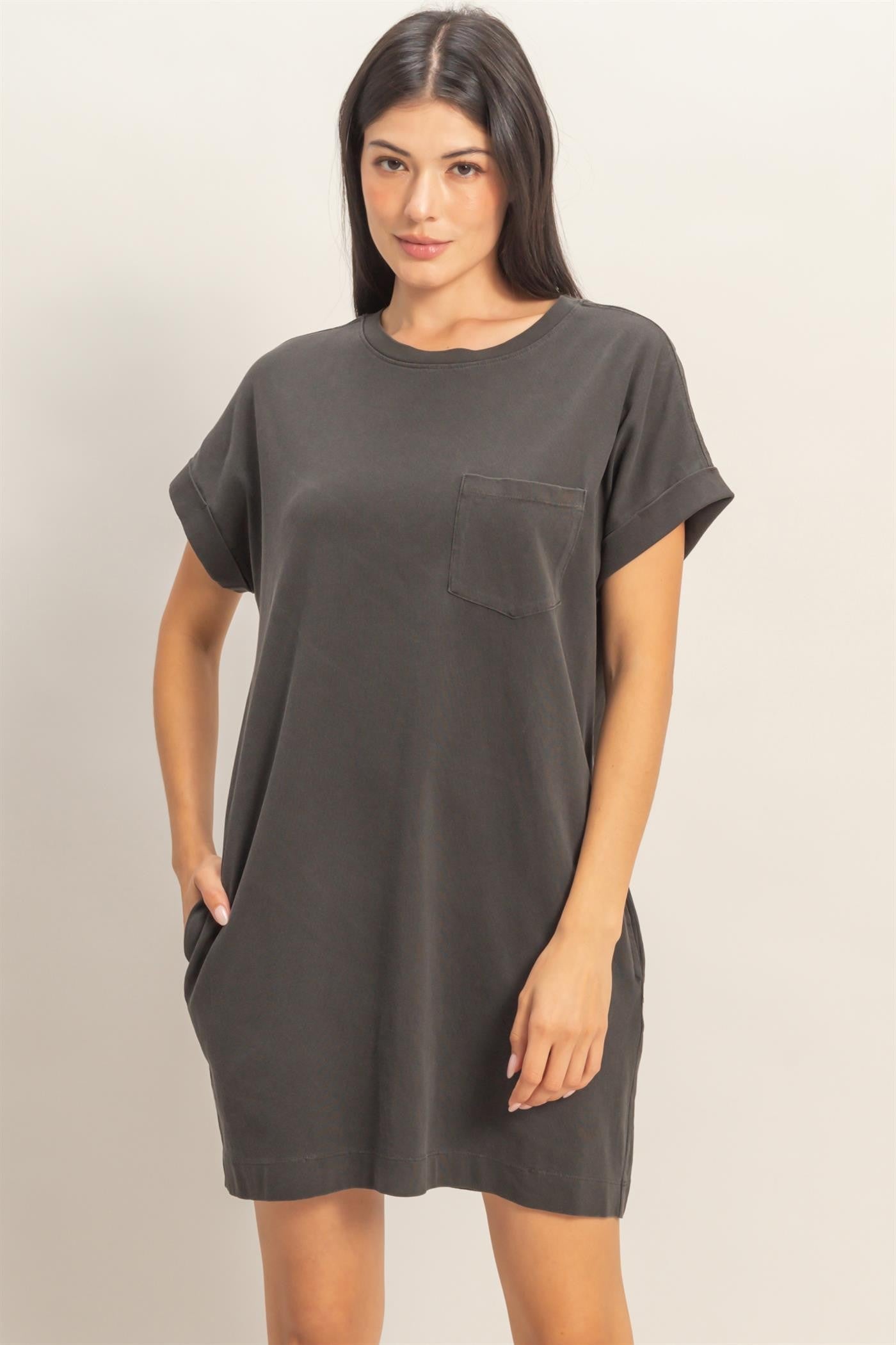 woman wearing a dark gray oversized t-shirt dress with short sleeves and a chest pocket