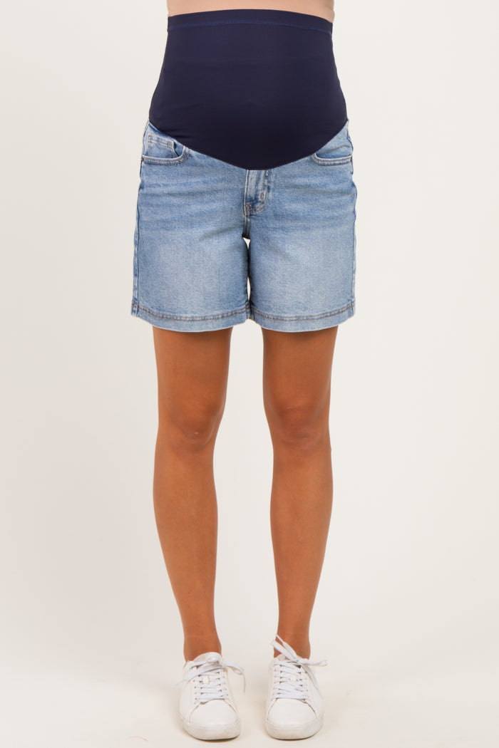 woman wearing light blue maternity denim shorts with a navy blue over-the-bump waistband