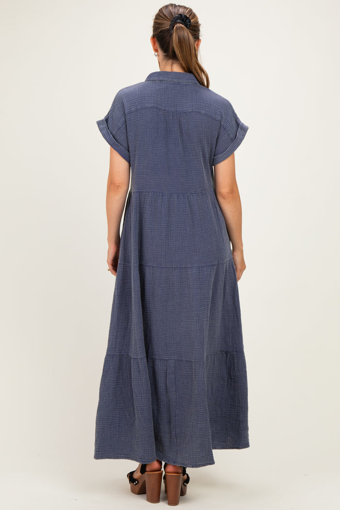 woman wearing a navy blue tiered maxi dress with short sleeves and a collared back view, showing a relaxed fit