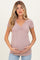 woman wearing a mauve ribbed short sleeve maternity top and holding her baby bump