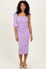woman wearing a lilac midi dress with one shoulder bow detail and a fitted silhouette