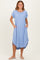 woman wearing a light blue short sleeve midi dress with side pockets and a curved hem
