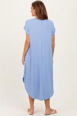 woman wearing a light blue ribbed maxi dress with short sleeves and a rounded hem, seen from the back