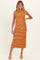 woman wearing a striped orange and black halter neck maternity dress, showing off her baby bump