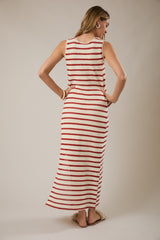 woman wearing a red and white striped sleeveless maxi dress, looking back, with a relaxed fit and side slits