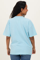 woman wearing a light blue oversized maternity t-shirt viewed from the back with short sleeves