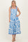 woman wearing a blue and white floral midi dress with tie straps and a flowing skirt
