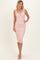 woman wearing a blush pink ribbed midi dress with a sweetheart neckline and a decorative knot detail on the front