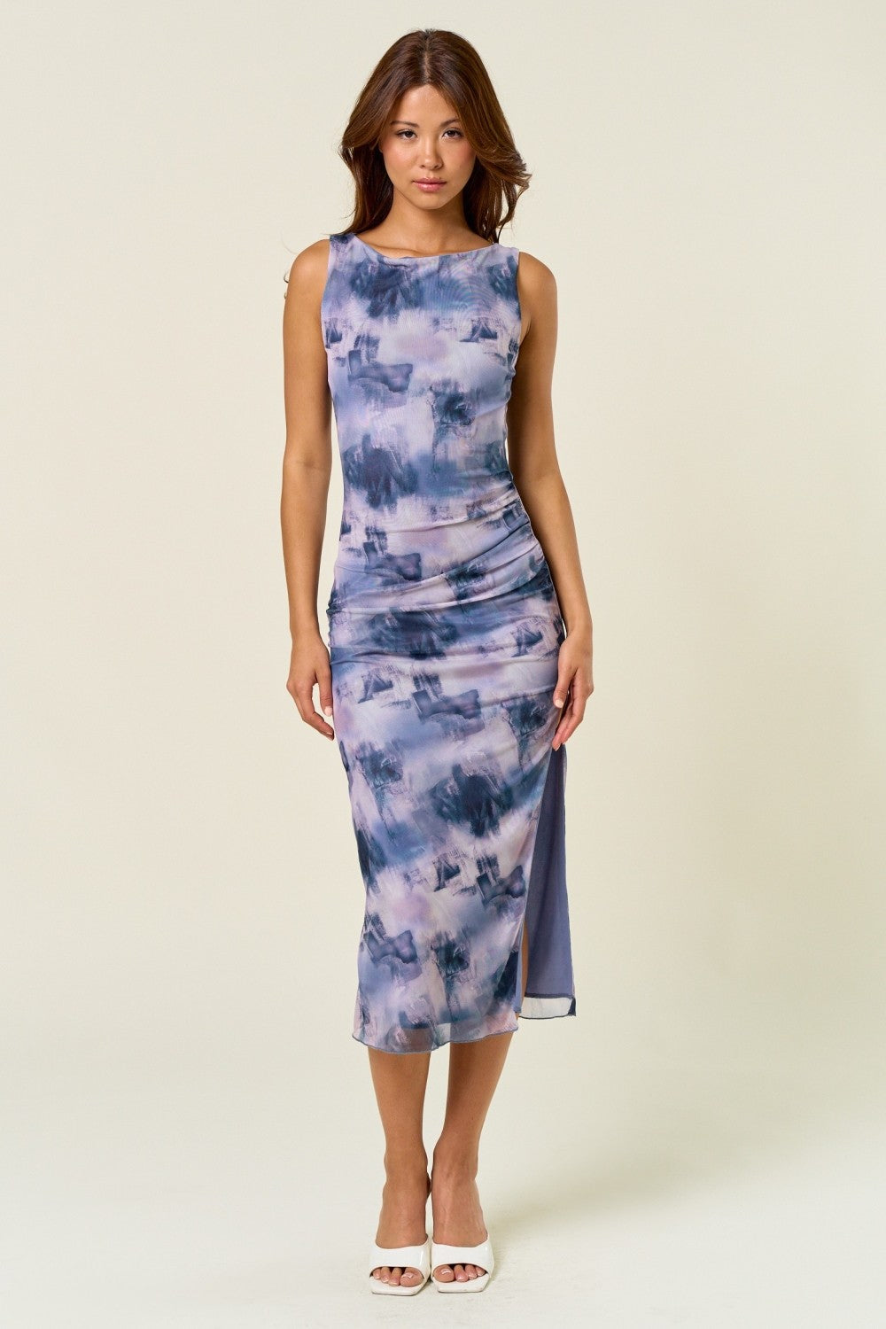 woman wearing a purple tie-dye midi dress with a scoop neckline and side slit