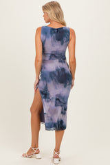 woman wearing a purple tie-dye maternity dress with a side slit, showcasing a stylish and comfortable fit