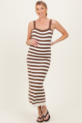 woman wearing a brown and white striped maternity maxi dress and holding her baby bump
