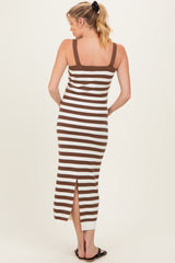 woman wearing a brown and white striped maternity dress with a side slit and a fitted silhouette