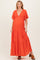 woman wearing a vibrant orange maternity maxi dress with a deep v-neckline and flutter sleeves, showcasing her baby bump