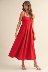 woman wearing a red sleeveless midi dress with a fitted bodice and flowing skirt
