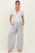 woman wearing a gray short sleeve maternity top and striped wide-leg maternity pants with pockets