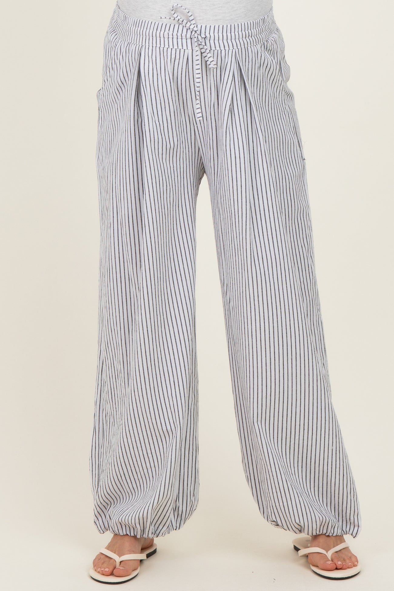 maternity wear striped wide-leg pants with a drawstring waist and pockets, model wearing sandals