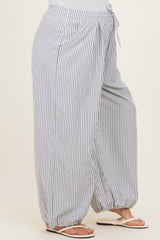 woman wearing gray and white striped maternity pants with an elastic waistband and drawstring