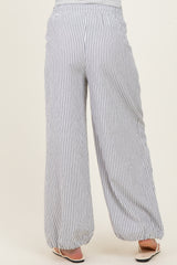 woman wearing light gray and white striped wide-leg maternity pants seen from the back