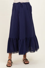 woman wearing a navy blue striped maternity maxi skirt with a lace hem and drawstring waist
