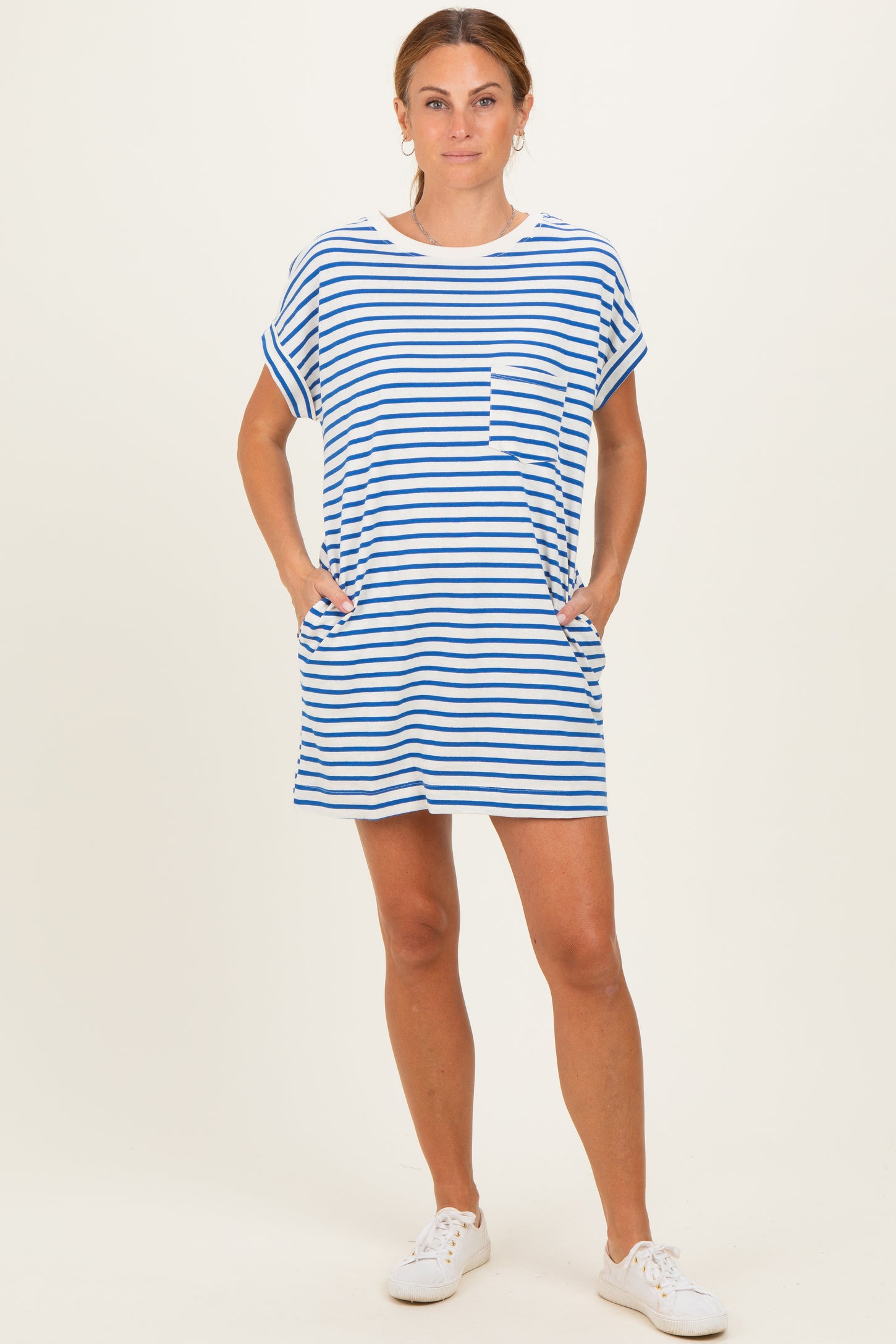 woman wearing a blue and white striped t-shirt dress with short sleeves and side pockets