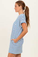 woman wearing a striped short sleeve mini dress with pockets in blue and white