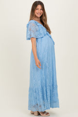 woman wearing a light blue lace maternity dress with ruffled sleeves and a flowy skirt, showing her baby bump