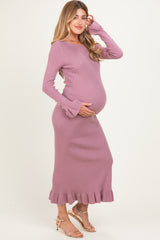 woman wearing a lavender ribbed maternity dress with ruffled hem and long sleeves, showing her baby bump