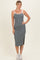 woman wearing a gray ribbed midi dress with white straps and side slit