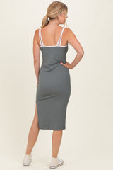 woman wearing a fitted gray midi dress with a slit at the back and thin straps, showing the back view