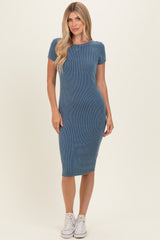 woman wearing a blue ribbed midi dress with short sleeves and a fitted silhouette