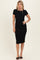 woman wearing a black ribbed midi dress with short sleeves and a fitted silhouette