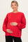 woman wearing a red oversized maternity sweatshirt and holding her baby bump