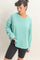 woman wearing a mint green oversized long sleeve sweatshirt and black bike shorts