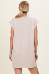 woman wearing a light taupe cap sleeve dress from the back