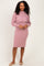 woman wearing a light pink two-piece ribbed dress with a cropped top and pencil skirt