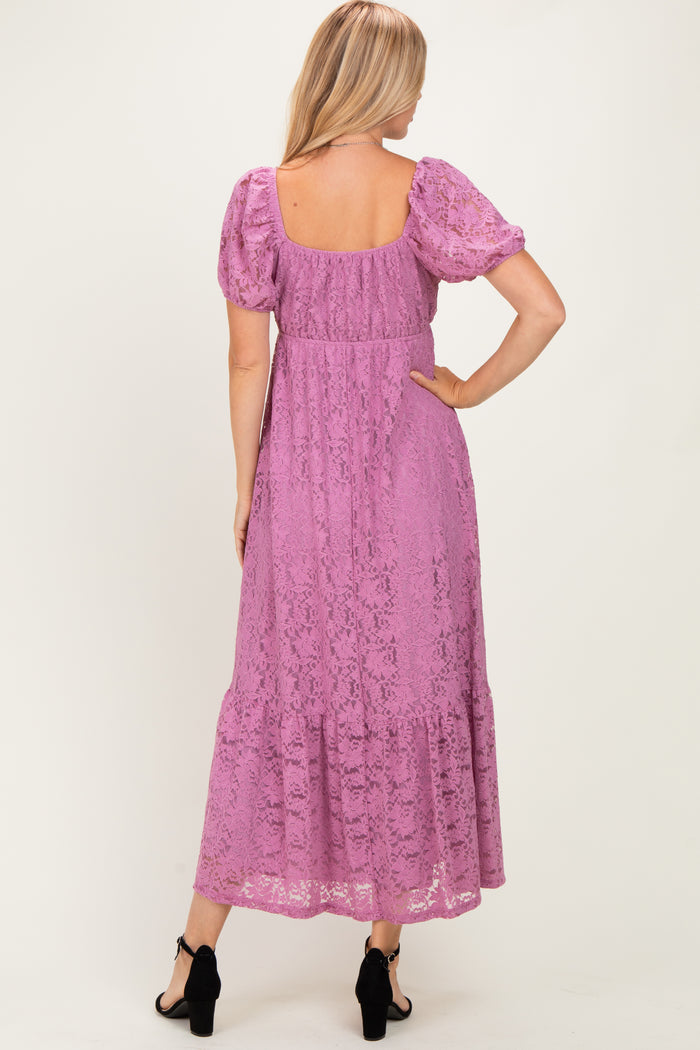 woman wearing a lilac lace maxi dress with puff sleeves and a tiered skirt, viewed from the back