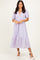 woman wearing a light purple puff sleeve midi dress with a deep v-neck and lace detailing