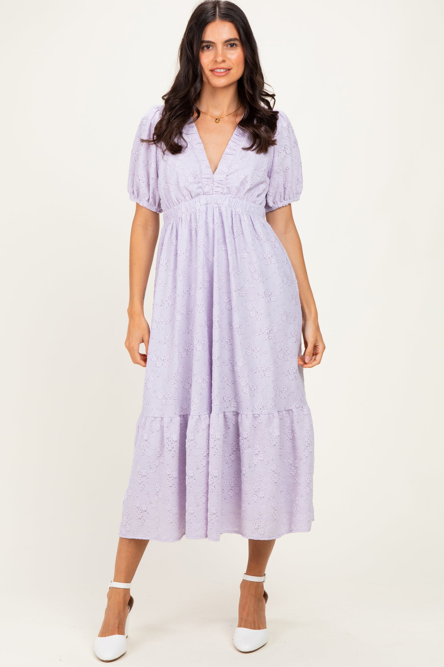 woman wearing a lavender puff sleeve midi dress with a v-neck and tiered hem
