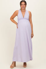 woman wearing a lavender maternity maxi dress with a plunging neckline and baby bump visible