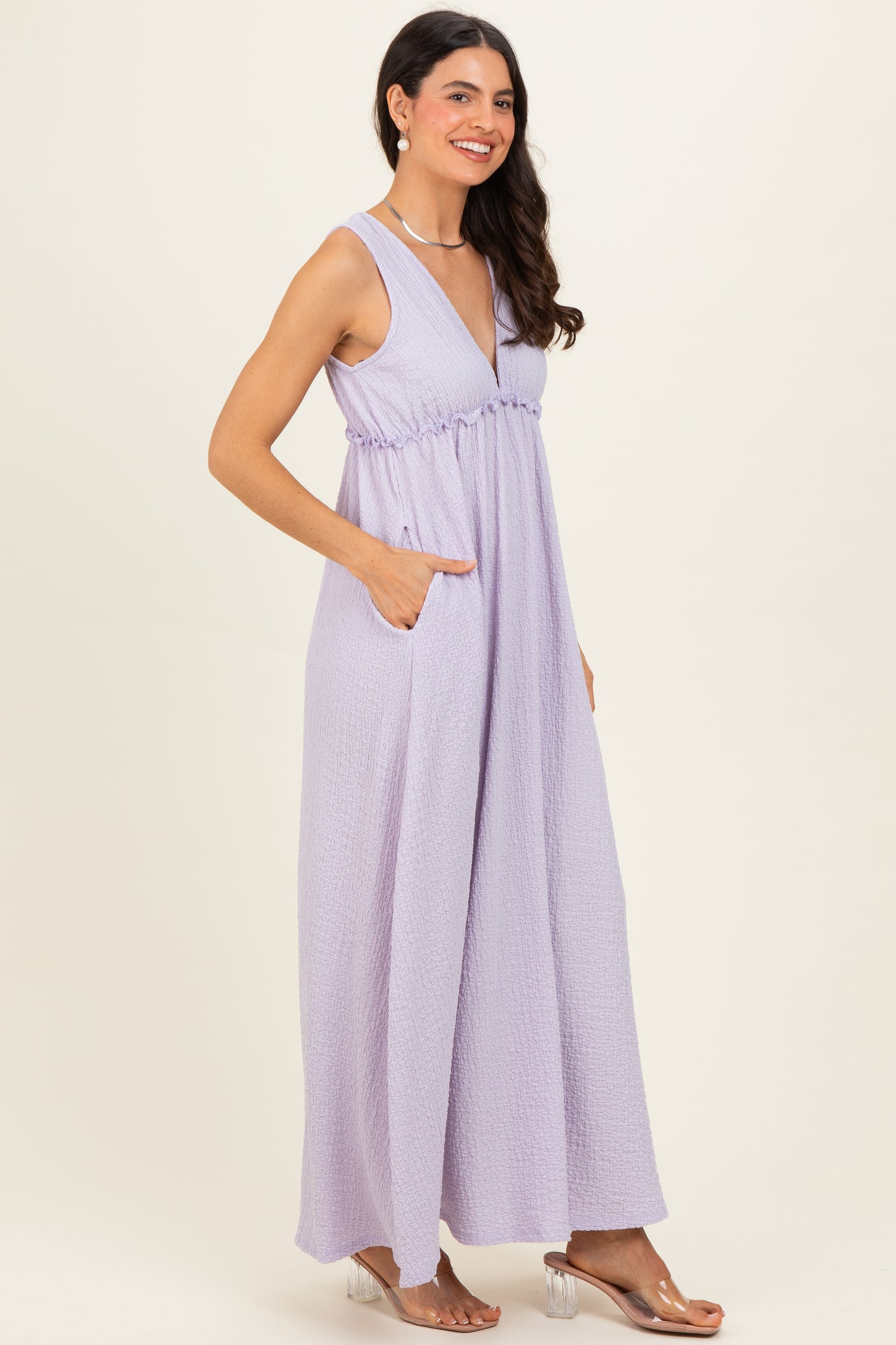 woman wearing a lavender sleeveless maxi dress with a v-neck and side pockets