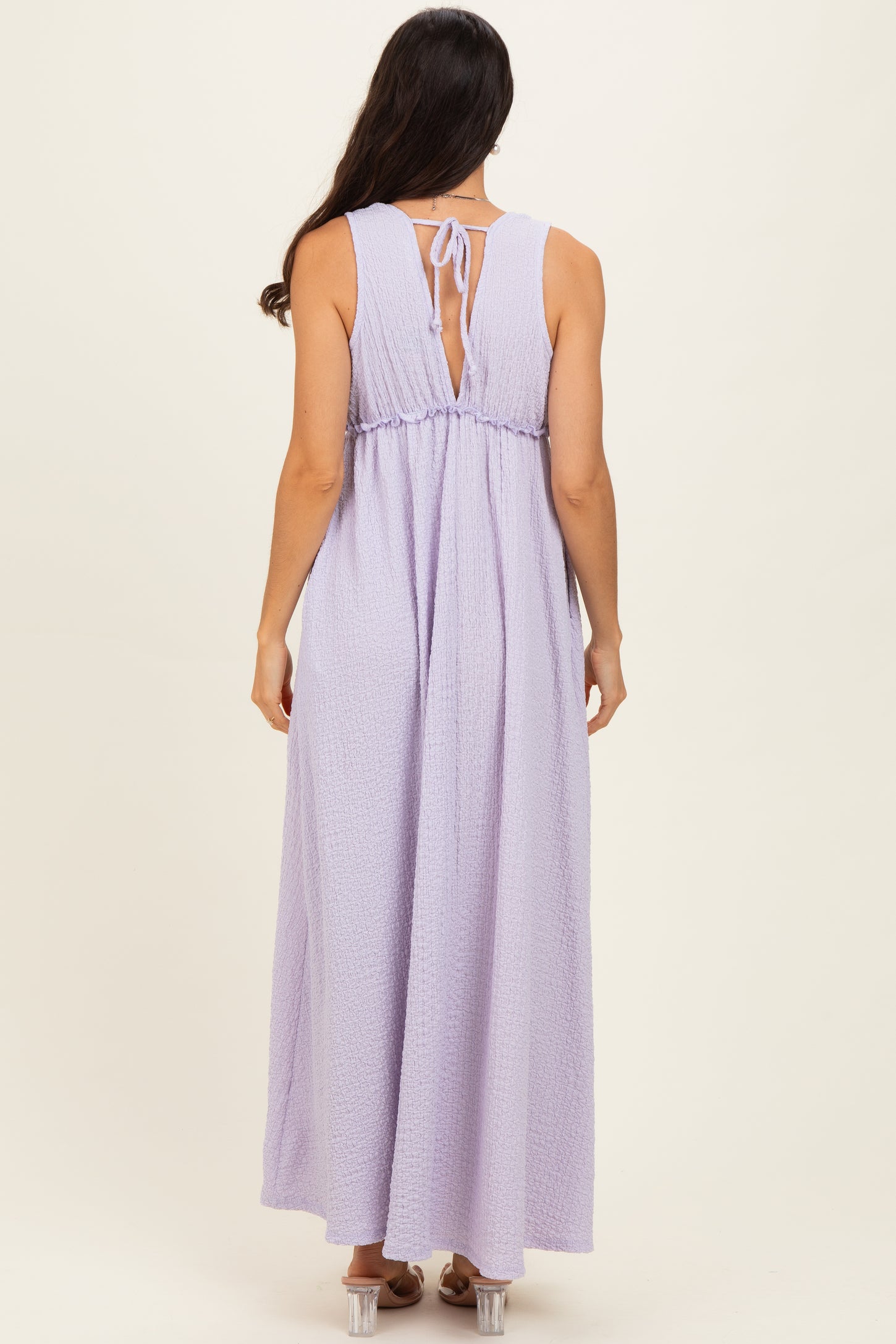 woman wearing a lavender maxi dress with a tied back detail and a relaxed fit