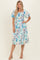 woman wearing a floral print midi dress with puff sleeves in blue and white