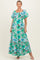 woman wearing a green floral print maxi maternity dress with short sleeves and a tiered skirt, showcasing her baby bump
