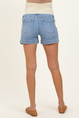 woman wearing light blue maternity shorts, showing a side view of the waistband and back pockets