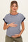 woman wearing a navy and white striped maternity top and holding her baby bump