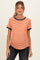 woman wearing an orange and white striped maternity top with navy blue trim and a visible baby bump