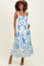 woman wearing a blue and white floral maternity maxi dress, showcasing her baby bump