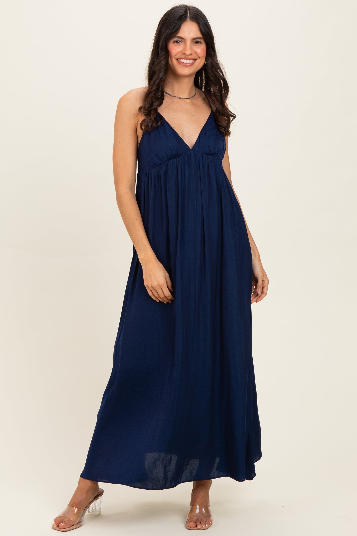 woman wearing a navy blue sleeveless maxi dress with a relaxed fit and a v-neckline